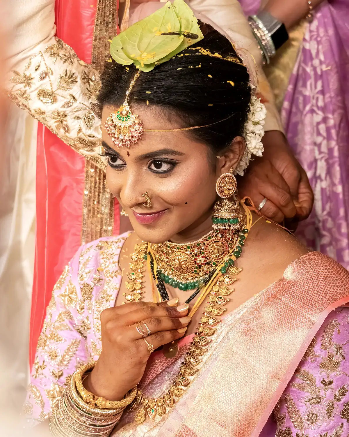 A bride looks down as the mangalsutra is tied during the mangalya dharanam